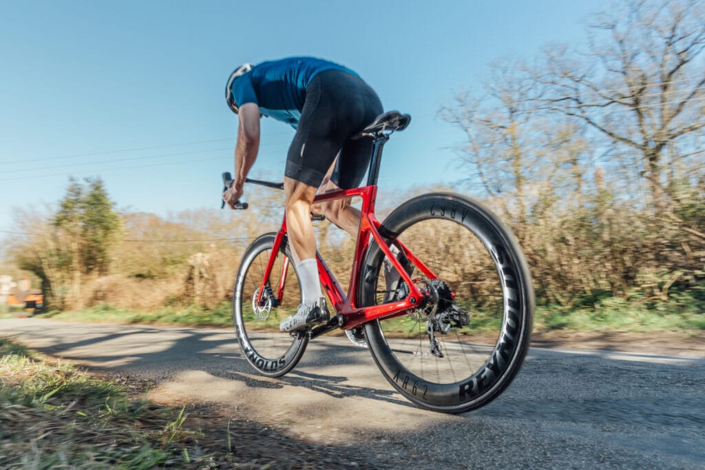 Ciclista treinando sozinho em uma estrada sem carros.