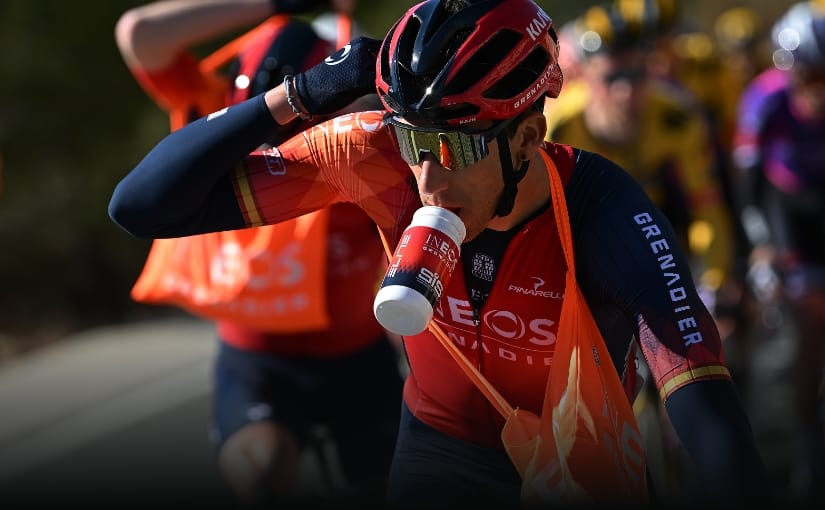 Ciclista profissional consumindo um líquido em sua garrafa.