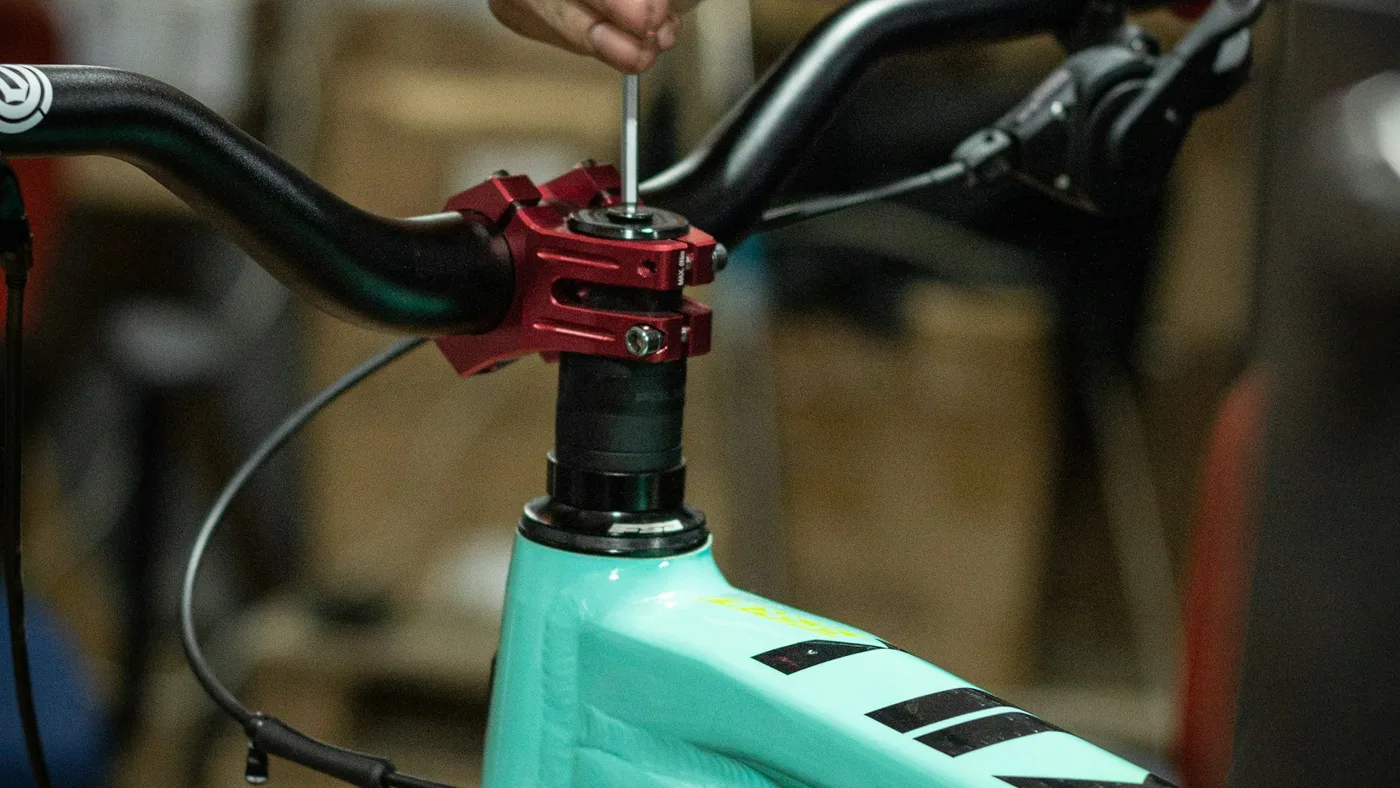 Pessoa fazendo manutencao em close na roda da bicicleta na oficina